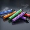 Colorful disposable vape devices on dark reflective surface with vapor